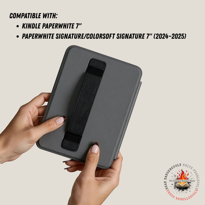 Gray case with black strap held by hands, compatible with Kindle Paperwhite 7" and Paperwhite Signature/Colorsoft Signature 7" devices.