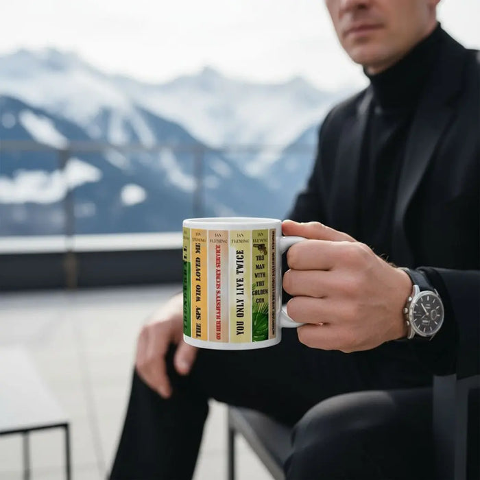 Person holding the James Bond Mug against a mountainous background