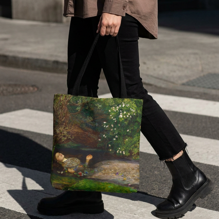 A person walking across a city crosswalk carrying a tote bag printed with a classical painting scene of a child in a garden. The person is wearing a brown shirt, black pants, and black boots.