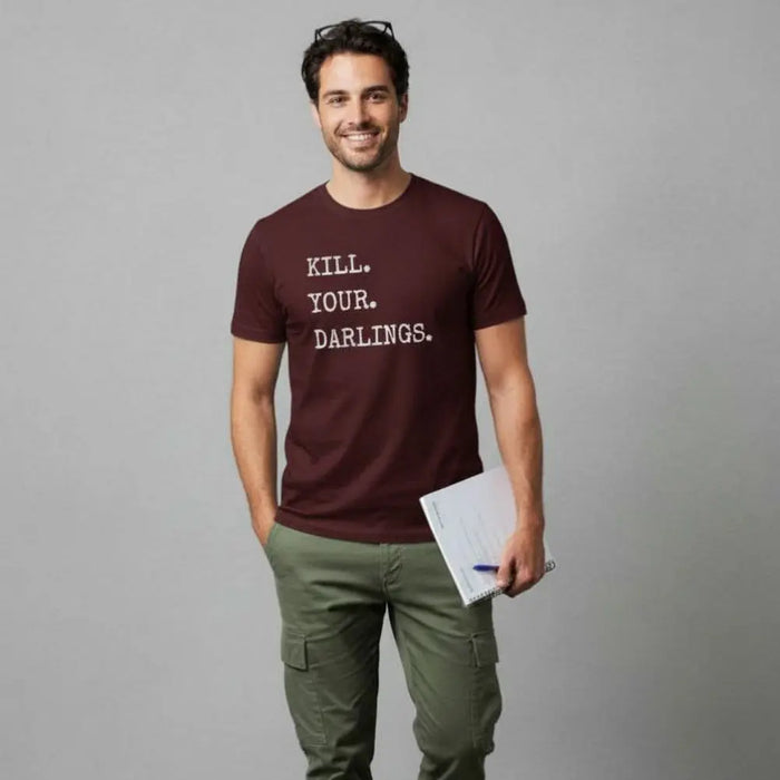 Writer wearing a KILL YOUR DARLINGS slogan maroon t-shirt with text, standing in an office setting.
