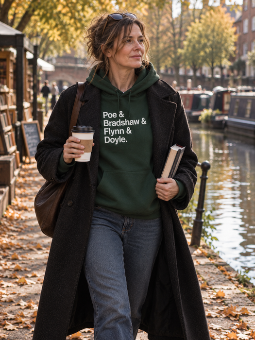 A woman walking along a canal path in autumn, wearing a dark green hoodie with the text 'Poe & Bradshaw & Flynn & Doyle.' in white.